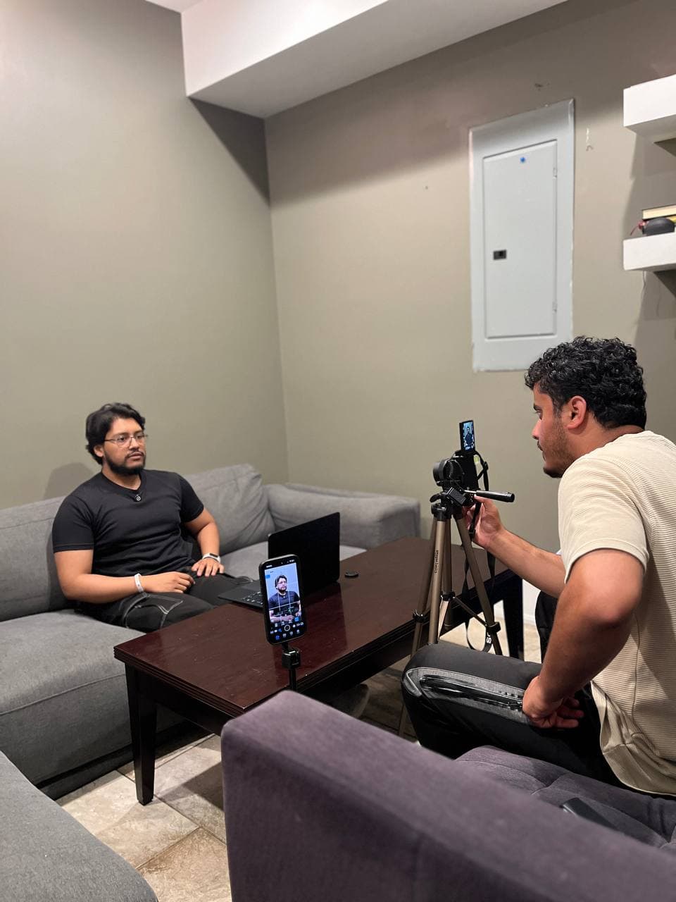 Syed filming a client interview with a multi-camera setup